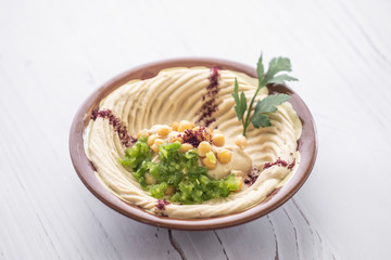 arab breakfast with hummus and falafel and fattah and foul on white wooden table Jordanian food 