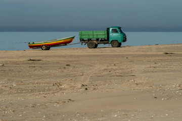 Old soviet truck towing a boat