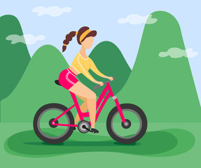 Girl rides a bicycle in the mountains