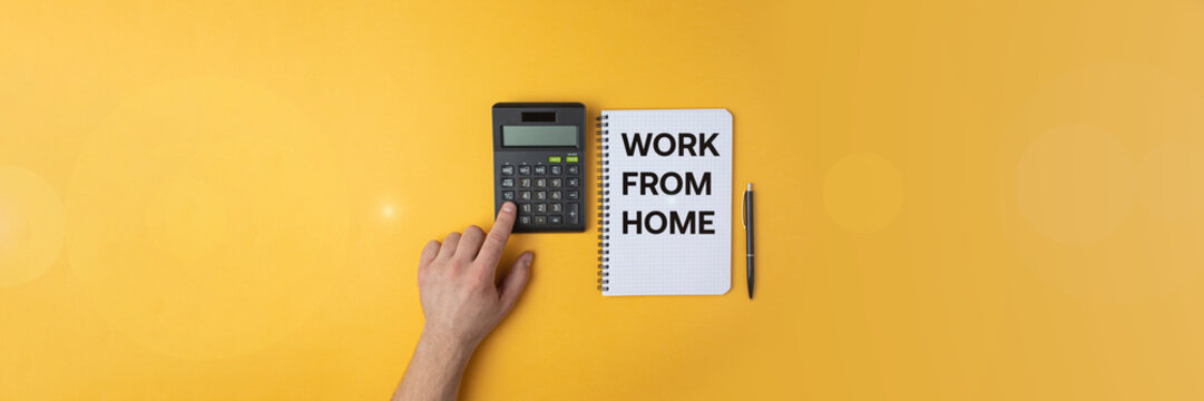 calculator in hand on a yellow background, the concept of working at home during the virus