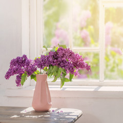 lilac in vase against the window on a sunny day