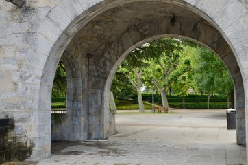 Fototapeta na wymiar Stone arch in garden in Pamplona, Spain