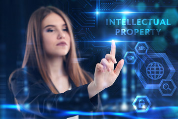 Business, Technology, Internet and network concept. Young businessman working on a virtual screen of the future and sees the inscription: Intellectual property