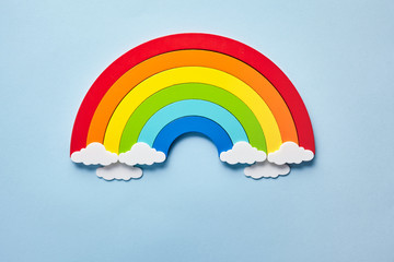 Vintage flat card with rainbow with white clouds on blue background. Chase the rainbow