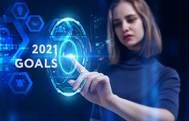 Business, Technology, Internet and network concept. Young businessman working on a virtual screen of the future and sees the inscription: 2021 goals
