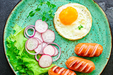 healthy breakfast, fried eggs sausages and vegetables Menu concept. food background. top view copy space for text keto or paleo diets