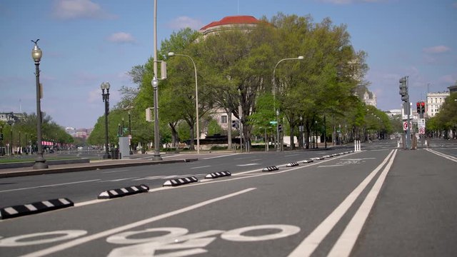 View from the opposite direction of the US Capitol on Pennsylvania Avenue with empty streets.