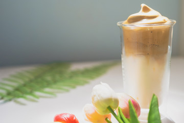 favorite and trend of summer drink from dalgona or frothy coffee with tulip decorate on white background