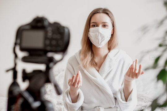 Young Girl Student In A Medical Mask Sits At Home In Quarantine In Isolation And Records A Video Vlog To Her Camera, Coronavirus News For Students, Stay Home