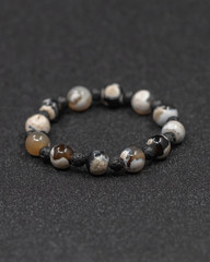 Round stone bracelets on a black background. Natural stone jewelry bracelets. bracelet made of stones.