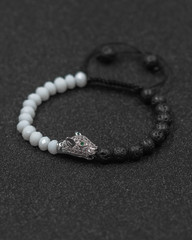 Round stone bracelets on a black background. Natural stone jewelry bracelets. bracelet made of...