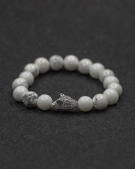 Round stone bracelets on a black background. Natural stone jewelry bracelets. bracelet made of stones.