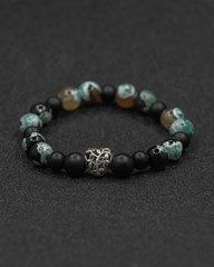 Round stone bracelets on a black background. Natural stone jewelry bracelets. bracelet made of stones.