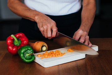 chef cutting vegetables on table