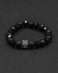Round stone bracelets on a black background. Natural stone jewelry bracelets. bracelet made of stones.