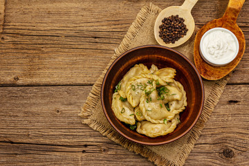 Dumplings stuffed stewed cabbage and sour cream. Traditional Ukrainian dish varenyky