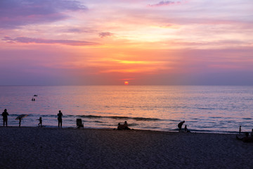 Fototapeta premium Sunset by the beach, relaxing on the beach, evening light, family on holiday