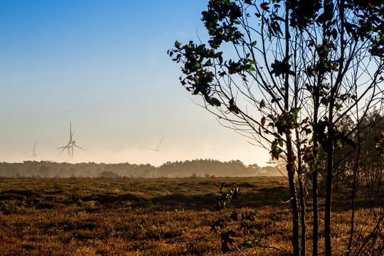 Wind turbines immersed in the morning mist near Pedralva. Solo Backpacker Trekking on the Rota Vicentina and Fishermen's Trail in Algarve, Portugal. Walking between cliff, ocean, nature and beach.
