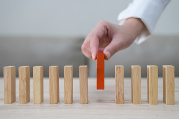 Domino,Wooden block,Business risk, strategy and planning concept idea.