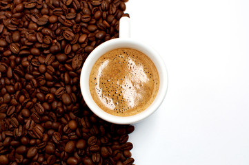white cup of fresh aromatic coffee and roasted coffee grains on a white background