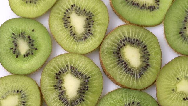 Kiwi slices closeup, macro food summer background, fruits top view. Rotate