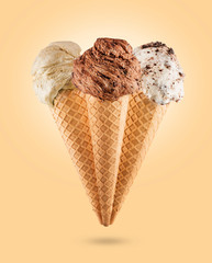 Ice cream cones with different flavors on colored background