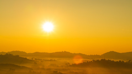 The morning sun and the orange sky above the mountains.
