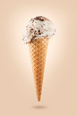 Stracciatella ice cream cone on colored background