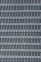 Overhead view of the interwoven plastic elements that make up the rattan effect that is used on outdoor plastic chairs and sofas.