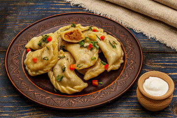 Dumplings stuffed stewed cabbage and sour cream. Traditional Ukrainian dish varenyky