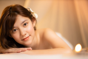 Asian Beautiful, young and healthy woman in spa salon. Massage treatment spa room  . Traditional medicine and healing concept.closed up face.