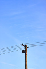 Old concrete electric pole with a lamp