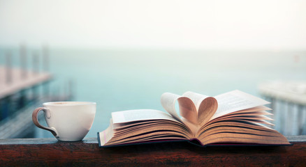 Book and coffee time by the seaside