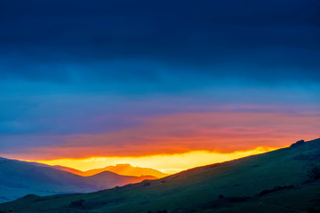 Obraz na płótnie Canvas Silhouetted Mountain at Sunset
