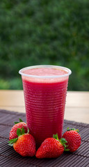 Strawberry juice on natural background