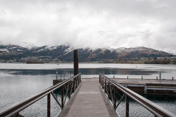 Fototapeta na wymiar Bridge to water taxi pier in on the shores of Lake Wakatipu, New Zealand