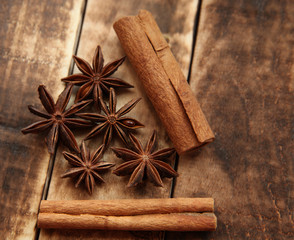 Star anise and cinnamon sticks on a wooden background