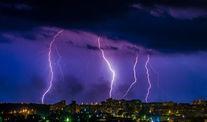 Obraz na płótnie Canvas Flashes of lightning in the night sky. Lightning strike. Lightning near the factory. Night sky. Storm cloud. A flash of lightning. Industrial landscape before the storm