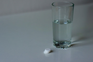 Glass of water and pills