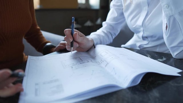 Close up of designers hands. Creative architect projecting on the drawings