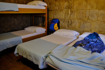 Bedroom in a Sigerico hostel. Solo Backpacker Trekking on the Via Francigena from Lucca to Siena. Walking between nature, history, churches,