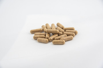 Drug capsule pills with beige medication in pile