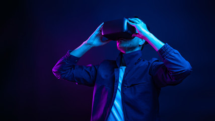 Fototapeta na wymiar Handsome young man using a virtual reality headset