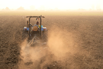 Farmer agriculture tractor asia farm Rice manioc,Asian farmers are driving tractor to adjust the...