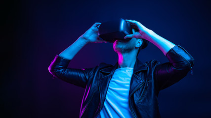 Fototapeta na wymiar Handsome young man using a virtual reality headset