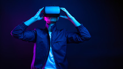 Handsome young man using a virtual reality headset