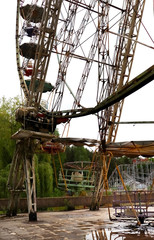 Abandoned city amusement park. Rusty Ferris Wheel.