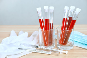 The blood of the disease detector was on the table with rubber gloves and syringes. 