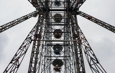 Abandoned city amusement park. Rusty Ferris Wheel.