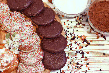 Scene with an assortment of baking, original Nuremberg gingerbread cookies on a wooden textured white background.Ingredients for a healthy breakfast.Coffee shop advertising concept.Close-up.Top view 